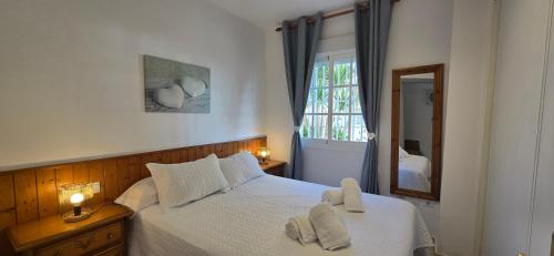 a bedroom with a bed with two towels on it at Peñoncillo Beach in Torrox Costa