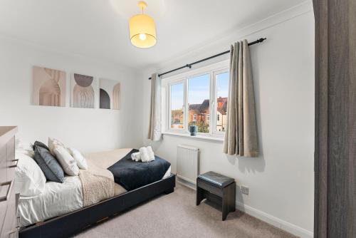 a bedroom with a bed and a window at The Derby Escape - Garden -Sleeps 6 in Derby