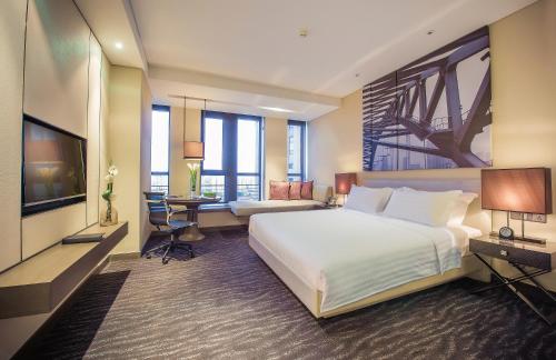 Postel nebo postele na pokoji v ubytování Pan Pacific Tianjin