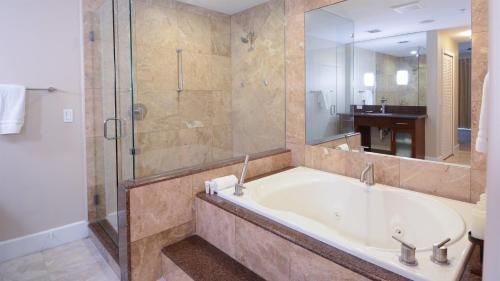 a large bathroom with a tub and a shower at 115 Mariners Club in Key Largo