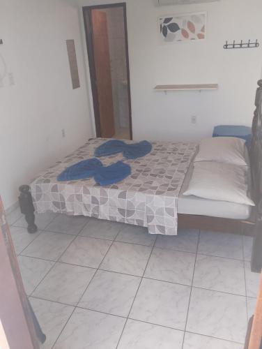 a bedroom with a bed with blue towels on it at residencial portuguesa in Parnamirim