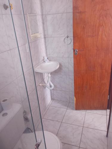 a bathroom with a toilet and a sink and a shower at residencial portuguesa in Parnamirim