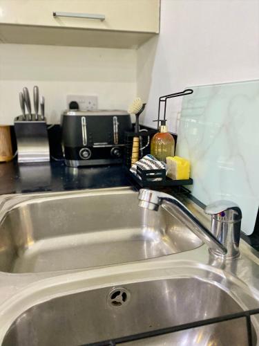 a kitchen counter with a sink and a counter top at Central Southsea Duplex Apartment 2BR Parking Dogs in Portsmouth