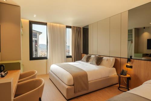 a hotel room with a bed and a desk at Hotel Pusi in Sauk