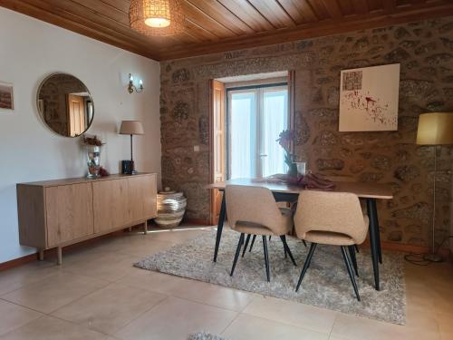 a dining room with a table and chairs and a window at Casa do Terreiro in Beiral do Lima
