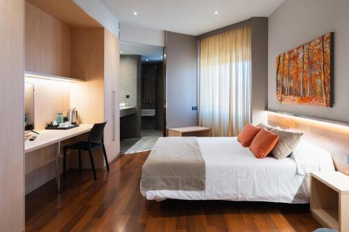 a hotel room with a bed and a kitchen at Hotel America Igualada in Igualada