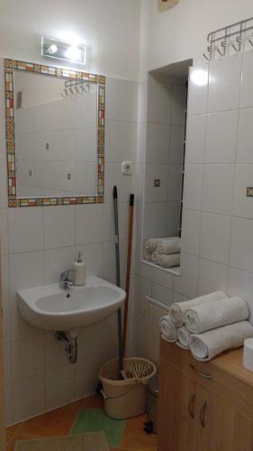 a bathroom with a sink and a mirror at Central Pécs Free Parking in Pécs