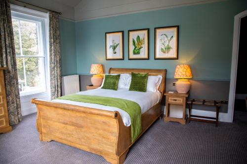 a bedroom with a bed and two lamps and a window at The Chalk Hare, Royston, Hertfordshire - Acorn Pubs in Royston