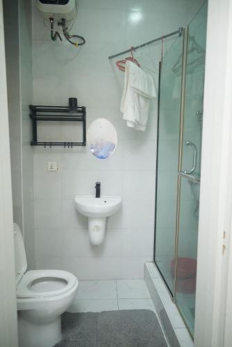 a bathroom with a toilet and a sink and a shower at The Jimi Stay in Maiyegun