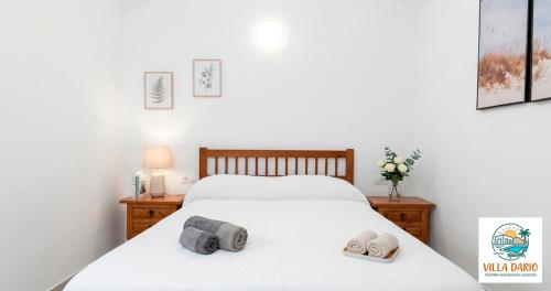 a bedroom with a bed with two slippers on it at Villa Darío en Nazaret in Nazaret