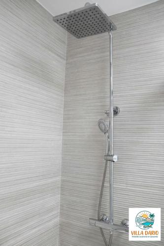 a shower with a shower head in a bathroom at Villa Darío en Nazaret in Nazaret