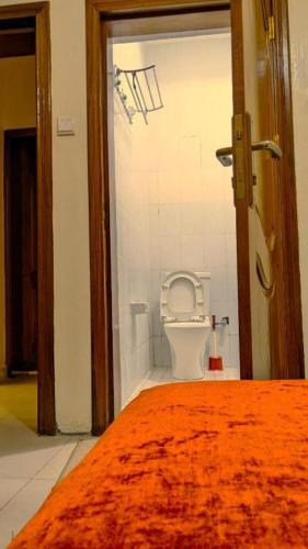 a bathroom with a toilet in a room at Bati Valley Guest House in Kigali