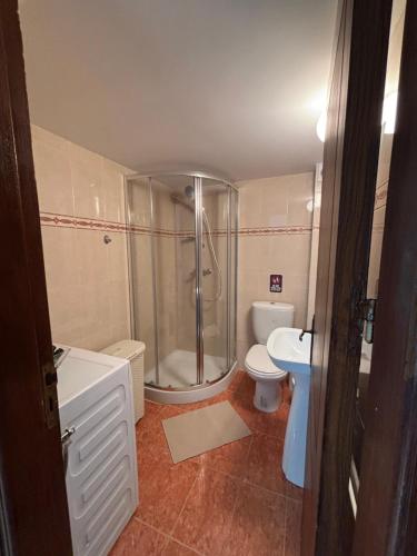 a bathroom with a shower and a toilet and a sink at Seafront Escape Apartment in Oroklini
