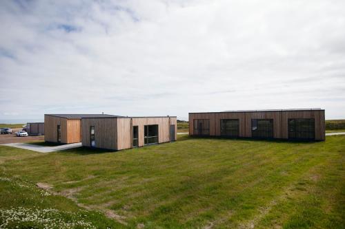 a couple of shipping containers on a grass field at Fell Holiday Home in Stapi