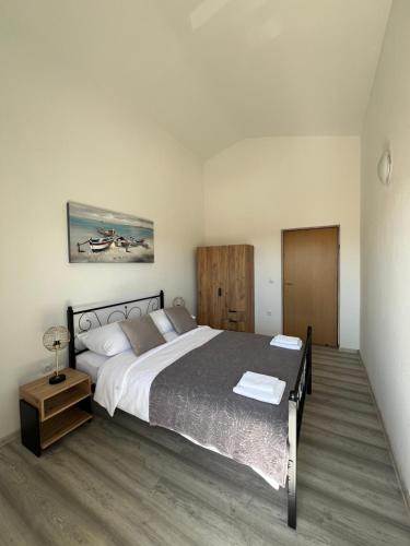 a bedroom with a large bed and a wooden floor at Villa K&F Borik in Zadar