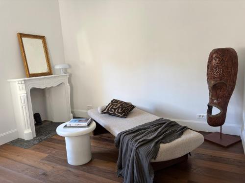a room with a bed and a chair and a fireplace at A Casa Di Rose in Ajaccio