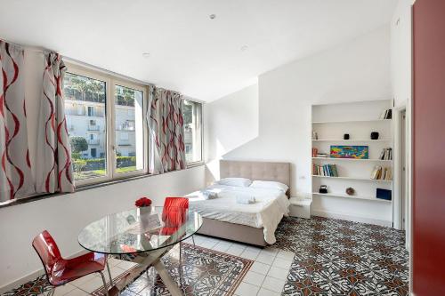 a bedroom with a bed and a glass table at Le Suite del Castello in Castellammare di Stabia