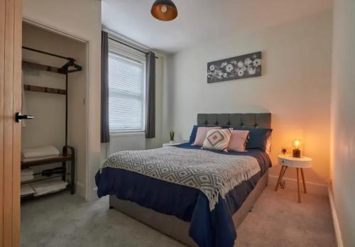 a bedroom with a bed and a window at The Quay Corner in Saint Thomas Station
