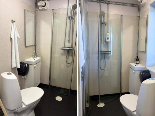 a bathroom with a glass shower and a toilet at Abisko Hostel in Abisko