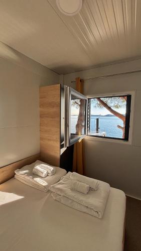a bedroom with two beds and a window at Hipo camp - Mobil home Sestrica in Pakoštane