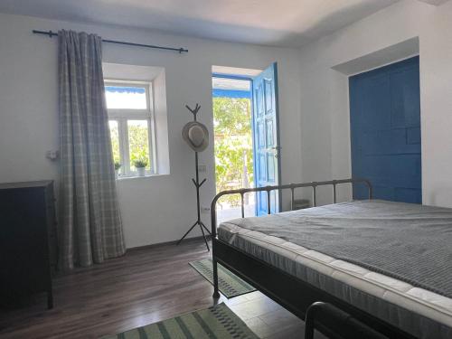 a bedroom with a bed and a large window at Casa Albastra in Mahmudia