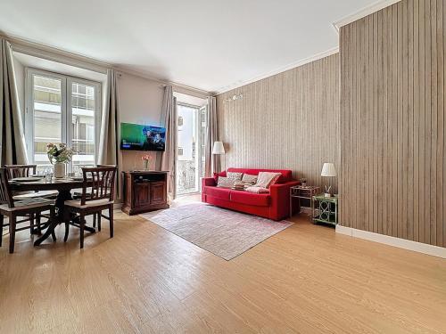 a living room with a red couch and a table at Sea View 2BR 2BA - 4 min Palais - Ideal Cannes Film Festival Stay in Cannes