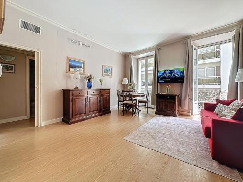 a living room with a red couch and a table at Sea View 2BR 2BA - 4 min Palais - Ideal Cannes Film Festival Stay in Cannes