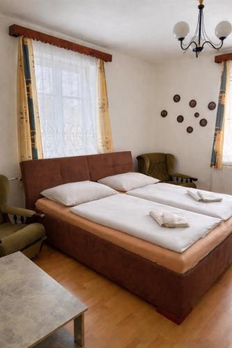 a bedroom with a large bed and a window at Apartmány v centru in Havlíčkŭv Brod