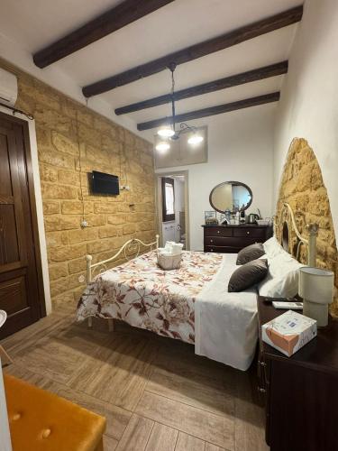a bedroom with a bed with a dresser and a mirror at b&b centro città in Agrigento