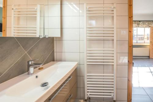 a bathroom with a sink and a mirror at FerienGut Gaarz - Im Park 3 in Göhl