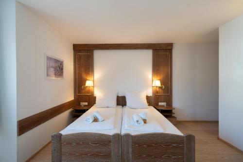 a bedroom with a bed with two pillows on it at Hotel Baeren in Leimen