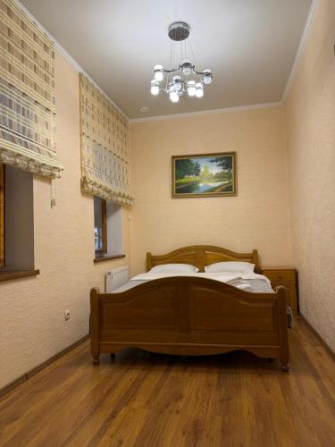 a bedroom with a bed and a chandelier at Bazar Apartment in Chişinău