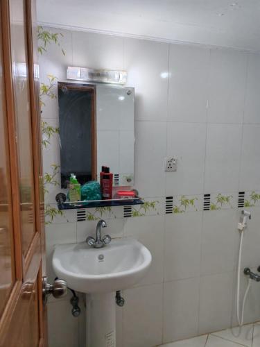 a bathroom with a sink and a mirror at Hotel Mohsin Plaza in Sreemangal