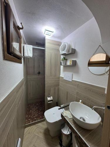 a bathroom with a white toilet and a sink at b&b centro città in Agrigento