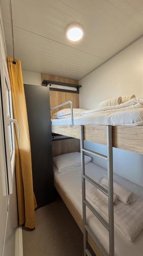 a small room with two bunk beds in it at Hipo camp Mobil home Arta in Pakoštane