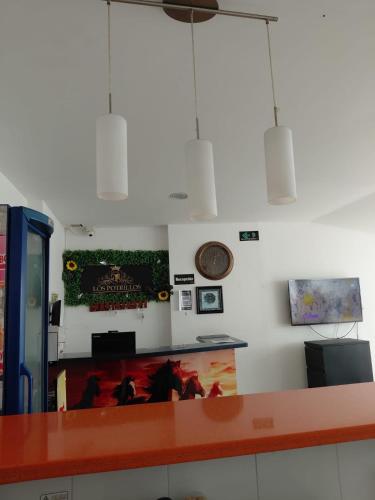 a waiting room with a counter and a counter top at Hotel Los Potrillos in Aguazul