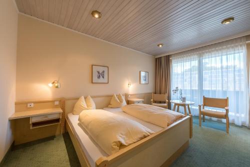 a bedroom with a large bed in a room at Hotel Gasthof Bräuwirth in Bergheim