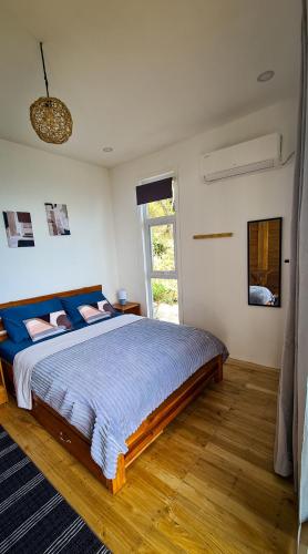 a bedroom with a large bed and a window at Balay Mariposa in Langagan