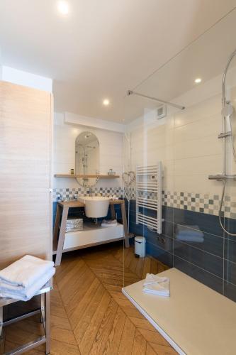 a bathroom with a shower and a sink and a tub at Villa Eze Vue Mer in Éze
