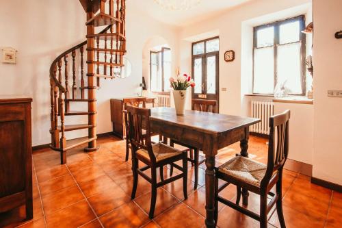 a dining room with a wooden table and chairs at La casa di Solcio - Lakeside srl L&B in Lesa