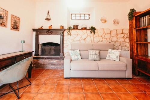 a living room with a couch and a fireplace at La casa di Solcio - Lakeside srl L&B in Lesa