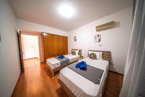 a hotel room with two beds and a window at Villa Stella with Jacuzzi in Oroklini