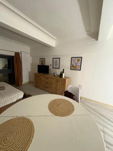 a room with a table and a bed and a television at Palazzo Bosco in Cosenza