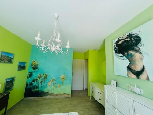 a room with a painting of a woman on the wall at A True Paradise for unforgettable vacation – Villa Pool and Sea View in Nice