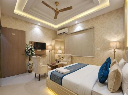 a hotel room with a bed and a table and chairs at Hotel Olive Aero Suites Near Delhi IGI Airport in New Delhi