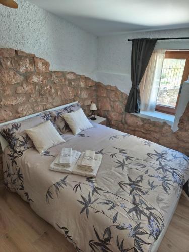 a bedroom with a bed with two books on it at Mas Lloretó - El Rossinyol in Copóns