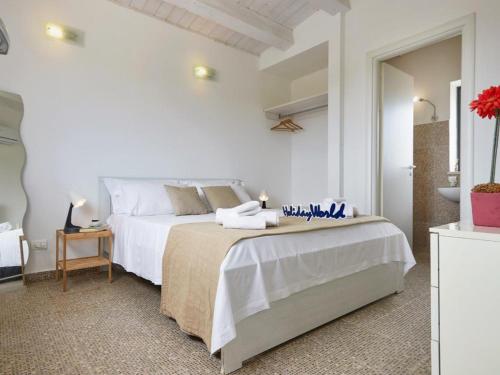 a white bedroom with two beds and a mirror at Villa Kika by holiday World in Ispica