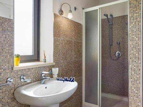 a bathroom with a sink and a shower at Villa Kika by holiday World in Ispica