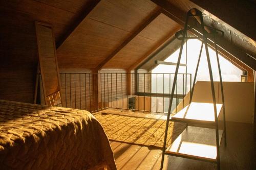 a room with a bed and a large window at Casa de Sobreiros in Amarante