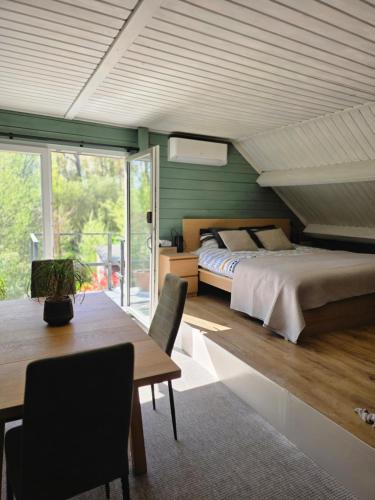 a bedroom with a bed and a table and chairs at StayTommy in Bertem